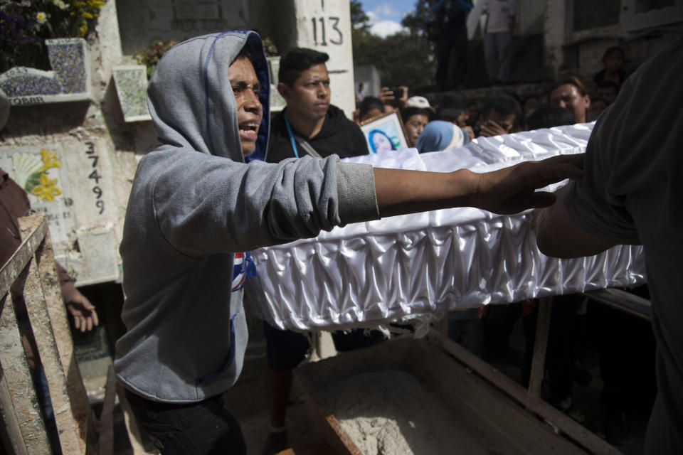 Relatives carry the coffin containing the remains of 17-year-old Siona Hernandez Garcia, a girl who died in a fire at the Virgin of the Assumption Safe Home, at the Guatemala City's cemetery, Friday, March 10, 2017. Families began burying some of the 36 girls killed in a fire at an overcrowded government-run youth shelter in Guatemala as authorities worked to determine exactly what happened. (AP Photo/Luis Soto)