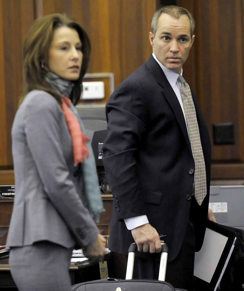 HFM SUN **FILE -In this Tuesday, March 9, 2010 file photo, Andrew Young, former aide to former Senator John Edwards, and his wife Cheri Young, get directions on where to store their suitcase full of documents and news clippings concerning Rielle Hunter during recess from a hearing in court, in Pittsboro, N.C. Despite the outrageous lies and years of cover-ups, Cheri and Andrew Young have stayed together. They are now reliving their volatile relationship with the Edwards family as the star witnesses in the former presidential candidate's campaign corruption trial. (AP Photo/Sara D. Davis, File)