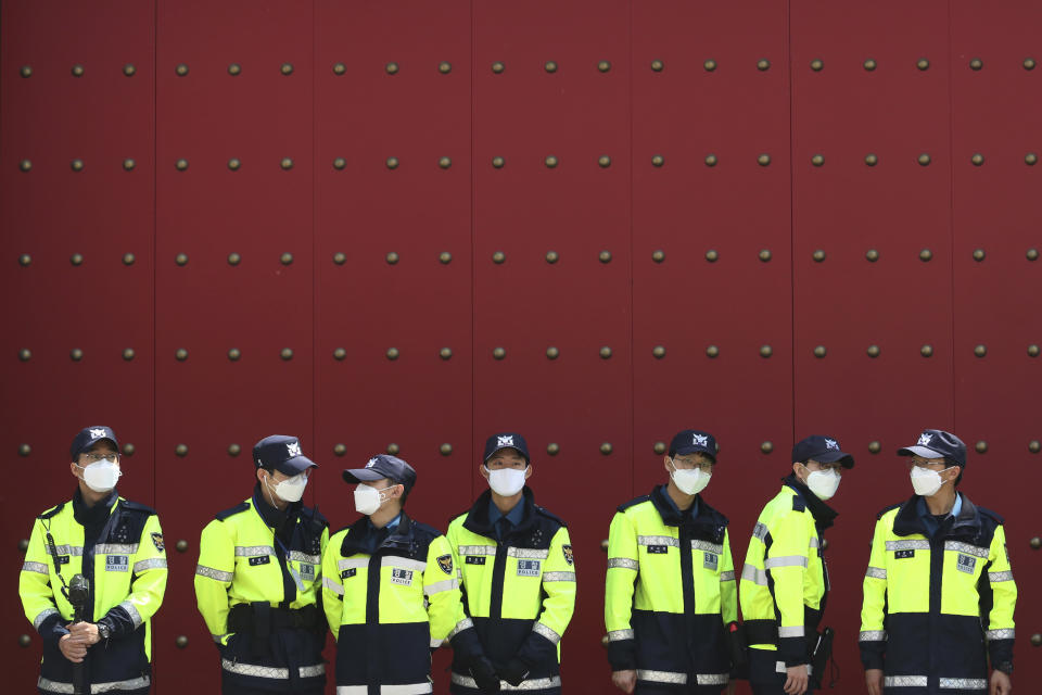 Police officers wearing face masks to help protect against the spread of the new coronavirus stand guard in front of the Chinese embassy in Seoul, South Korea, Wednesday, May 27, 2020. (AP Photo/Ahn Young-joon)