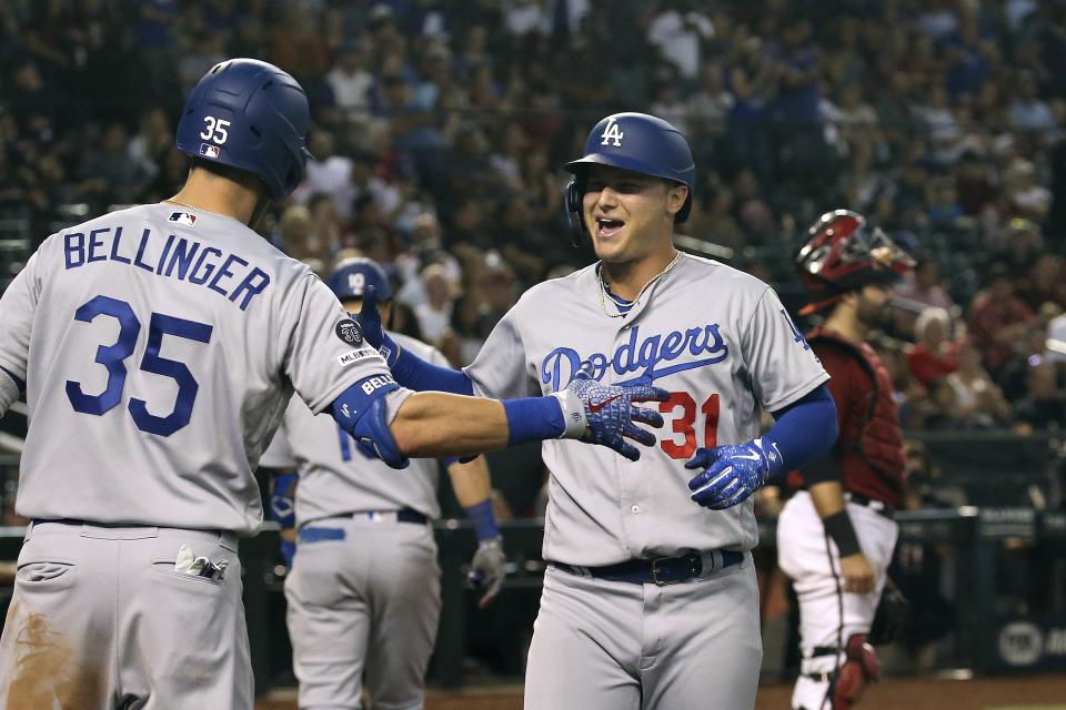 Los Angeles Dodgers' Joc Pederson (31) celebrates his home run against the Arizona Diamondbacks with Dodgers' Cody Bellinger (35) during the 11th inning of a baseball game Sunday, Sept. 1, 2019, in Phoenix. The Dodgers defeated the Diamondbacks 4-3. (AP Photo/Ross D. Franklin)