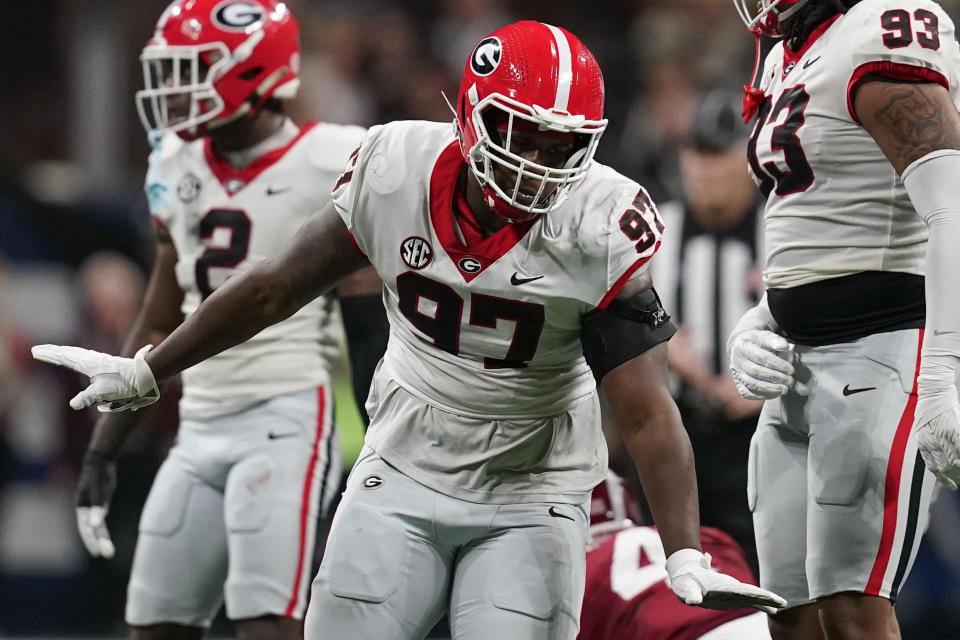 Georgia defensive lineman Warren Brinson (97) celebrates after sacking Alabama quarterback Jalen Milroe (4)during the first half of the Southeastern Conference championship NCAA college football game in Atlanta, Saturday, Dec. 2, 2023. (AP Photo/Mike Stewart)