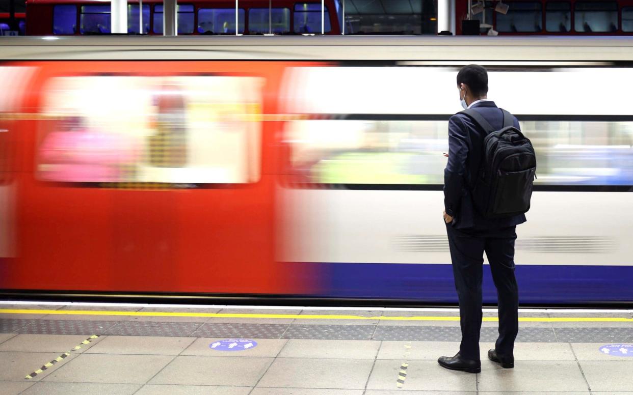 A man waits on the platform for a tube train amid the coronavirus disease (COVID-19) pandemic in London, in October 2020 - HANNAH MCKAY/Reuters