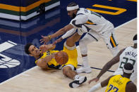 Indiana Pacers guard Malcolm Brogdon (7) and Utah Jazz guard Mike Conley, right, battle for a loose ball in the first half during an NBA basketball game Friday, April 16, 2021, in Salt Lake City. (AP Photo/Rick Bowmer)
