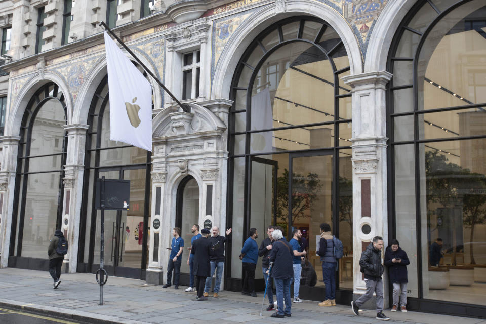 Members of staff stand outside of the Apple Store informing people of their closure, on Regent Street, London, Saturday, March 14, 2020. Tech giant Apple is closing its stores outside of China for two weeks and will only sell online as part of efforts to fight the global viral pandemic. “In our workplaces and communities, we must do all we can to prevent the spread of COVID-19,” CEO Tim Cook tweeted Saturday. “Apple will be temporarily closing all stores outside of Greater China until March 27 and committing $15M to help with worldwide recovery." For most people, the new coronavirus causes only mild or moderate symptoms. For some, it can cause more severe illness, especially in older adults and people with existing health problems. (Rick Findler/PA via AP)