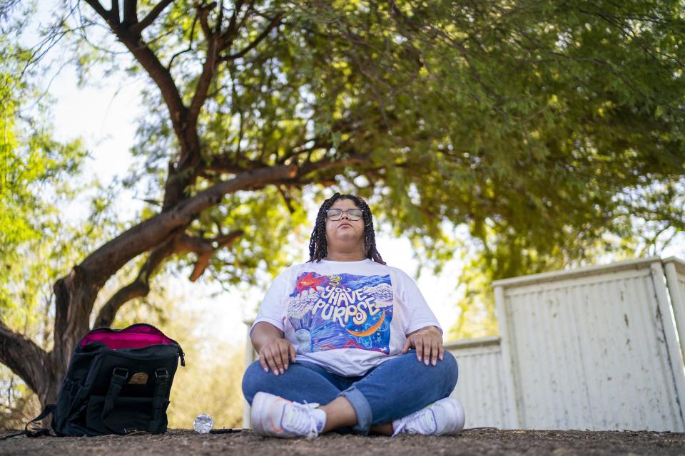 Amiagh Jade Scott, who receives services through Foster360, a Mesa United Way initiative that provides housing, mentorship and help for young adults aging out of foster care, meditates at the Riparian Preserve at Water Ranch on Oct. 22, 2022, in Gilbert. Scott enjoys being in nature and frequently visits the preserve to help center herself.