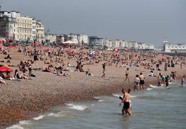 People enjoy the hot weather on the beach in Brighton
