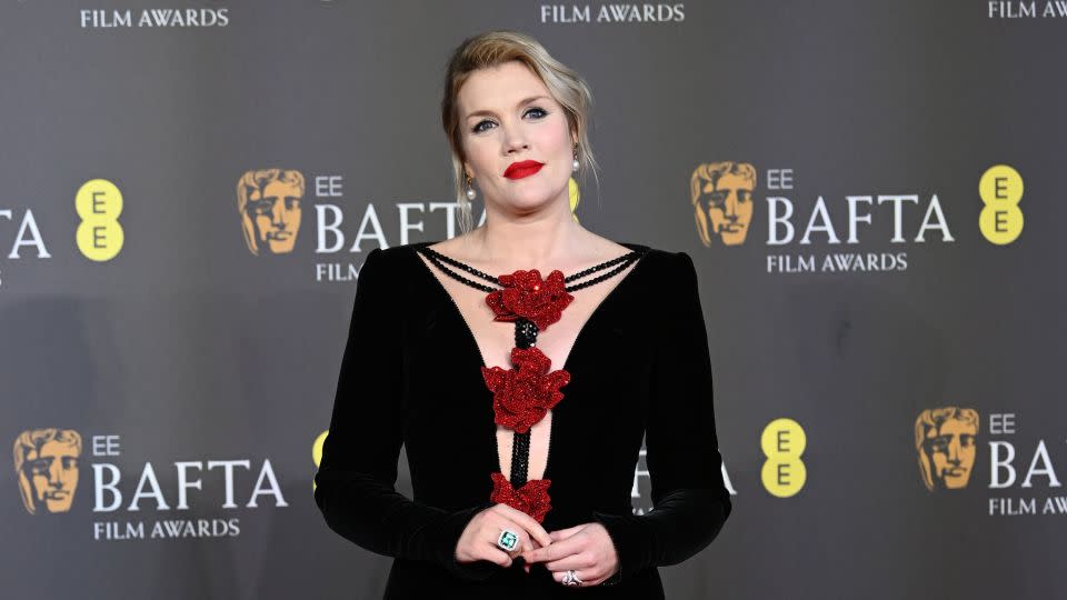 "Saltburn" director Emerald Fennell in an Armani gown embellished with sparkling red flowers. - Joe Maher/BAFTA/Getty Images