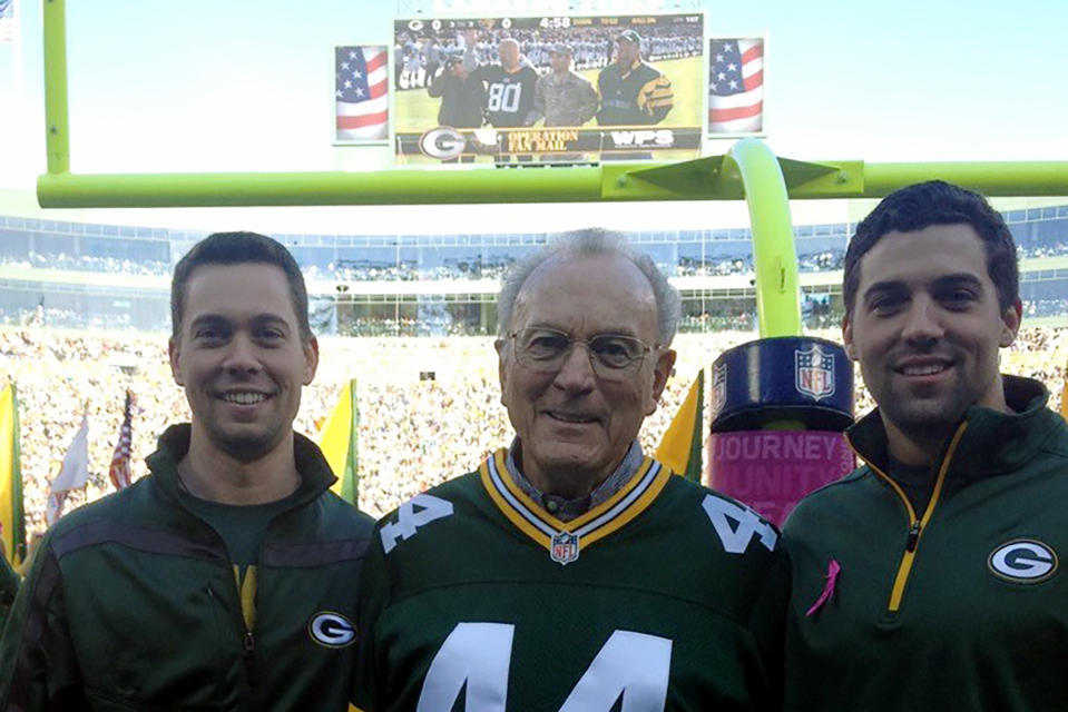 In this October 2012 photo provided by Karen Gooch, former Green Bay Packers football player Bobby Dillon is shown flanked by his grandsons Dillon Gooch, left and Weston Gooch during ceremonies at Lambeau Field in Green Bay, Wisc. Dillon passed away at age 89 in August 2019, five months before he was selected for the Hall of Fame as part of the centennial class. (Karen Gooch via AP)