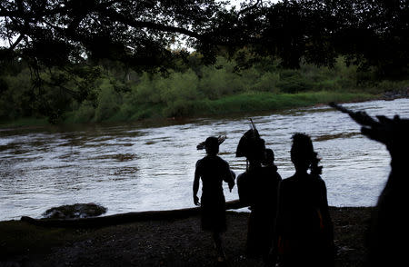 Indigenous people from the Pataxo Ha-ha-hae tribe are seen next to Paraopeba river, after a tailings dam owned by Brazilian mining company Vale SA collapsed, in Sao Joaquim de Bicas near Brumadinho, Brazil January 28, 2019. REUTERS/Adriano Machado
