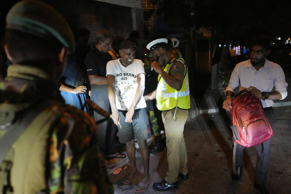 Sri Lankan police officers search a commuter during a search operation against narcotics in Colombo, Sri Lanka, Thursday, Jan. 18, 2024. (AP Photo/Eranga Jayawardena)