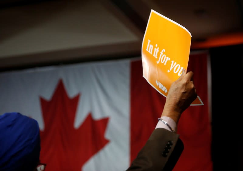 Supporter Rajinder Pandher holds a Jagmeet Singh sign at an NDP election night party in Burnaby