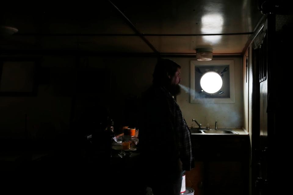 Captain Paulo Valente takes a break in the galley of the fishing boat Fisherman which is having a new engine installed.