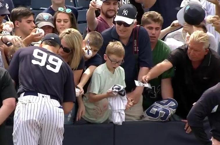 New York Yankees slugger Aaron Judge made a young fan’s day by signing his jersey. (MLB)