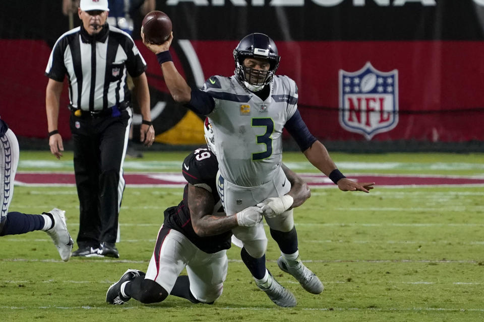 Seattle Seahawks quarterback Russell Wilson (3) gets the throw off as Arizona Cardinals linebacker Kylie Fitts makes the hit during the second half of an NFL football game, Sunday, Oct. 25, 2020, in Glendale, Ariz. (AP Photo/Rick Scuteri)