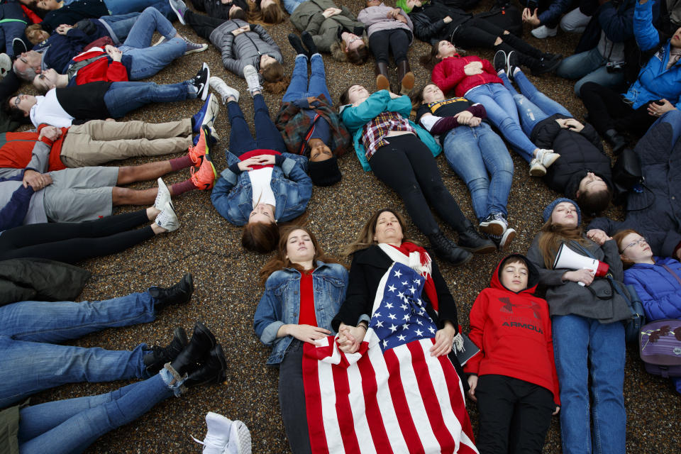 <p>Abby Spangler and her daughter Eleanor Spangler Neuchterlein, 16, hold hands as they participate in a “lie-in” during a protest in favor of gun control reform in front of the White House, Monday, Feb. 19, 2018, in Washington. (Photo: Evan Vucci/AP) </p>