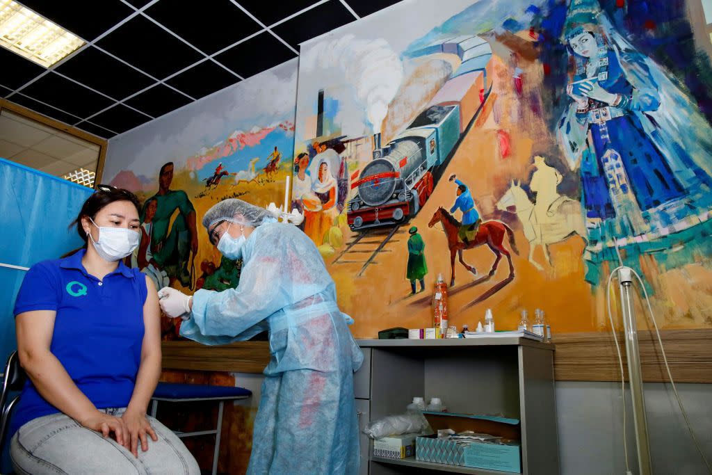 A woman in Almaty, Kazakhstan, receives a dose of the Sputnik V vaccine developed in Russia on April 17.