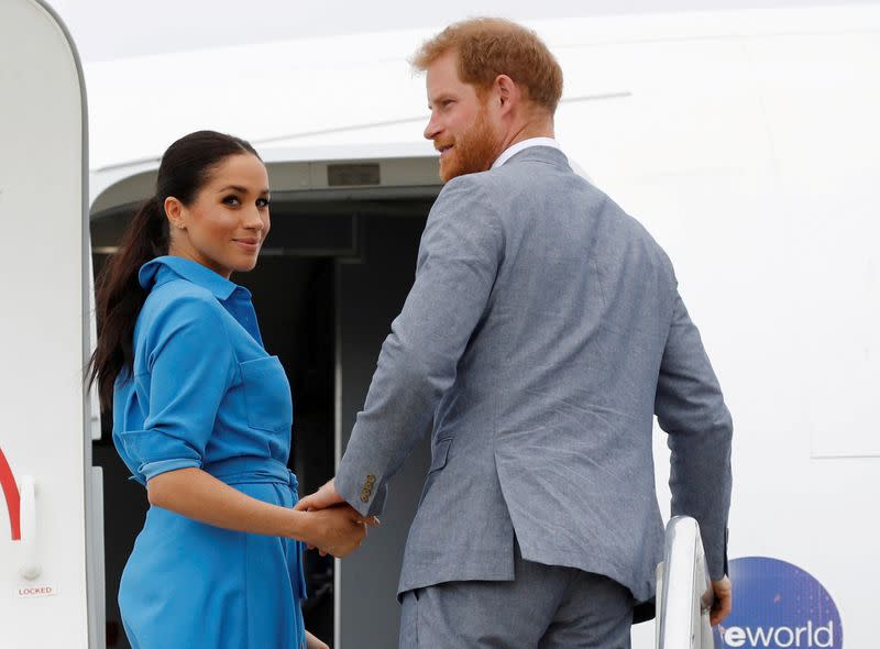 FILE PHOTO: Britain's Prince Harry and Meghan, Duchess of Sussex look on before departing from Fua'amotu International Airport in Tonga