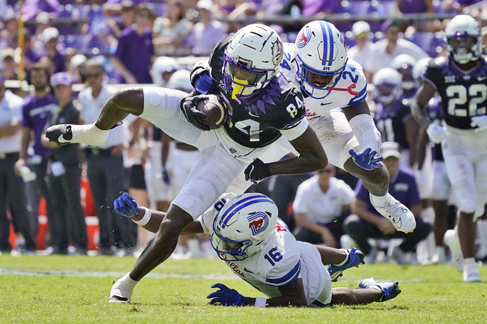 TCU wide receiver Warren Thompson (84) catches a pass against SMU defenders Ahmaad Moses (16) and Kobe Wilson (24) during the second half of an NCAA college football game Saturday, Sept. 23, 2023, in Fort Worth, Texas. (AP Photo/LM Otero)