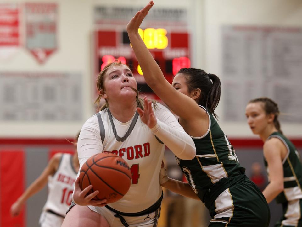 Nyah Mullins of Bedford muscles her way to the basket against St. Mary Catholic Central’s Ava Villarreal during a 48-33 Bedford win Friday night.