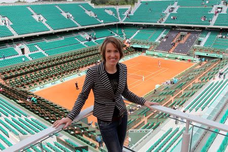 Former Belgian tennis player Justine Henin poses on top roof of the Philippe Chartrier court as she attends as TV consultant the quarter-final matches at the French Open tennis tournament at the Roland Garros stadium in Paris June 5, 2012. REUTERS/Francois Lenoir
