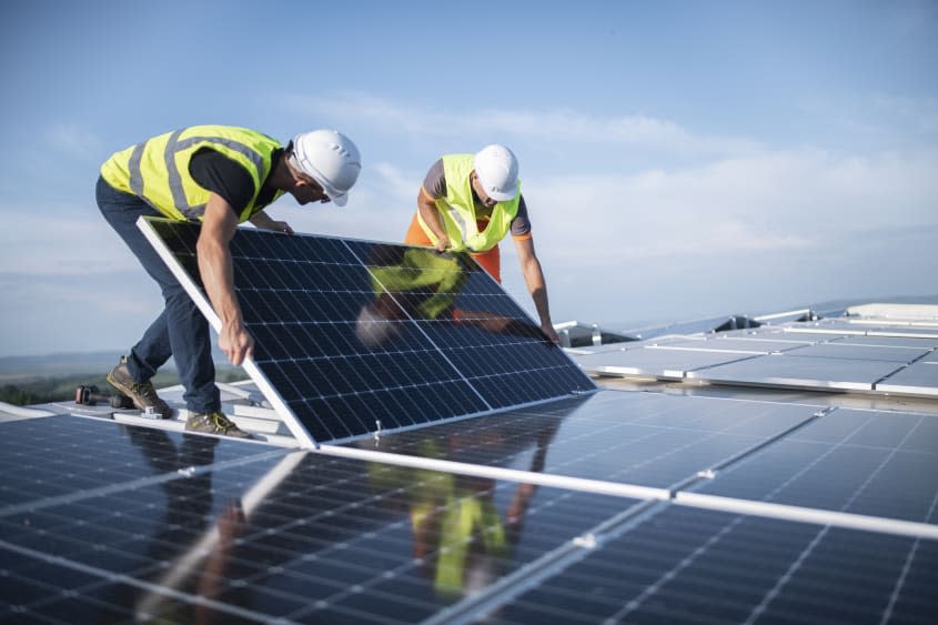 Men installing solar panels