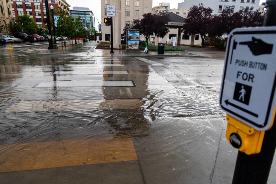 Water pools over a crosswalk in a flooded area of downtown Boise during a flash thunderstorm. Hail was also reported.