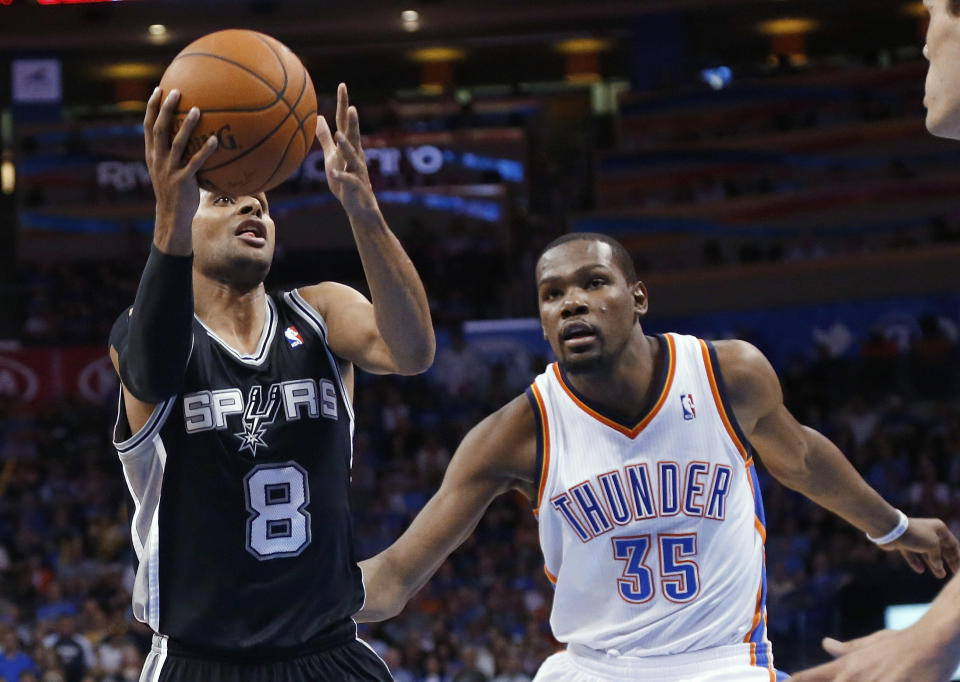 San Antonio Spurs guard Patty Mills (8) drives past Oklahoma City Thunder forward Kevin Durant (35) in the fourth quarter of an NBA basketball game in Oklahoma City, Thursday, April 3, 2014. Oklahoma City won 106-94. (AP Photo/Sue Ogrocki)