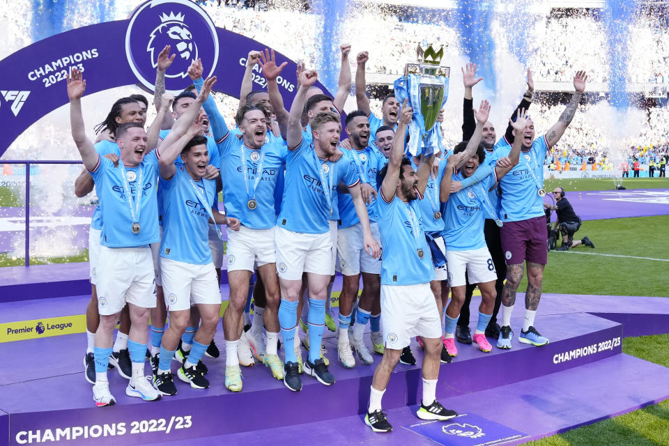 Manchester City players celebrate their Premier League title after the English Premier League soccer match between Manchester City and Chelsea at the Etihad Stadium in Manchester, England, Sunday, May 21, 2023. (AP Photo/Jon Super)