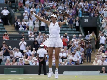 Garbine Muguruza of Spain celebrates after winning her match against Timea Bacsinszky of Switzerland at the Wimbledon Tennis Championships in London, July 7, 2015. REUTERS/Henry Browne