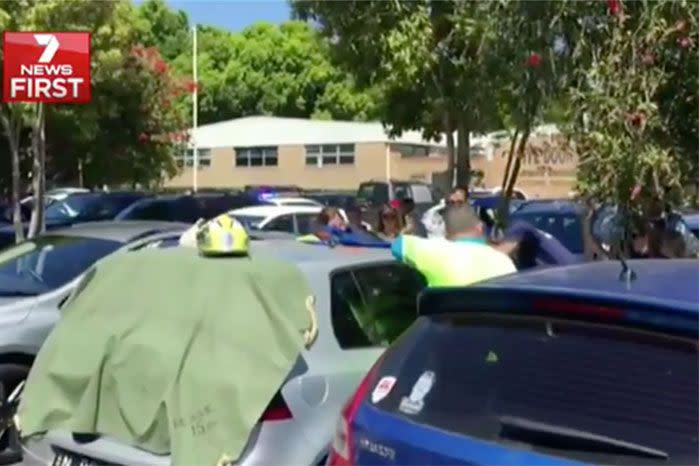 Emergency crews covered the car's back window with a tarp, in an attempt to cool it down. Photo: 7 News.