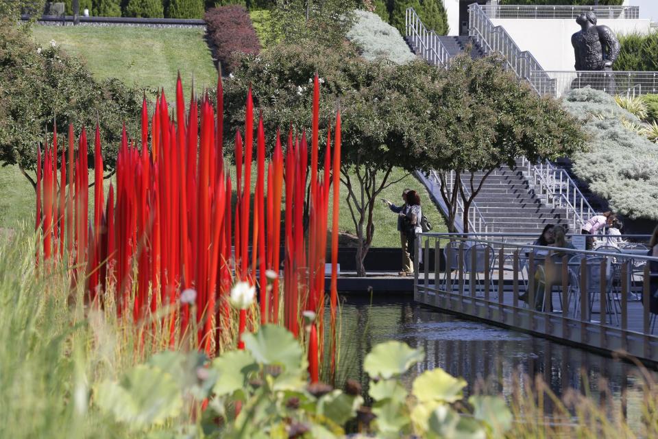 This Oct. 1, 2013 photo shows a sculpture by internationally renowned glass artist Dale Chihuly in the sculpture garden of the Virginia Museum of Fine Arts in Richmond, Va. The Virginia Museum of Fine Arts houses more than 33,000 works of art spanning 5,000 years of world history. (AP Photo/Steve Helber)
