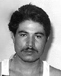 Julio Merida is wanted in the murders of two men at Providence's Merino Park in 1987.