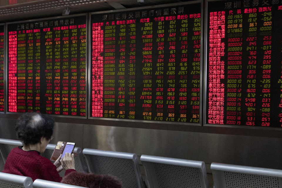 In this Thursday, Jan. 16, 2020, photo, an investor monitors stock prices at a brokerage in Beijing. Asian stock markets on Friday, Jan. 17 have followed Wall Street higher after China reported its economy grew by 6.1% in 2019 and Washington and Beijing signed an interim trade agreement. (AP Photo/Ng Han Guan)