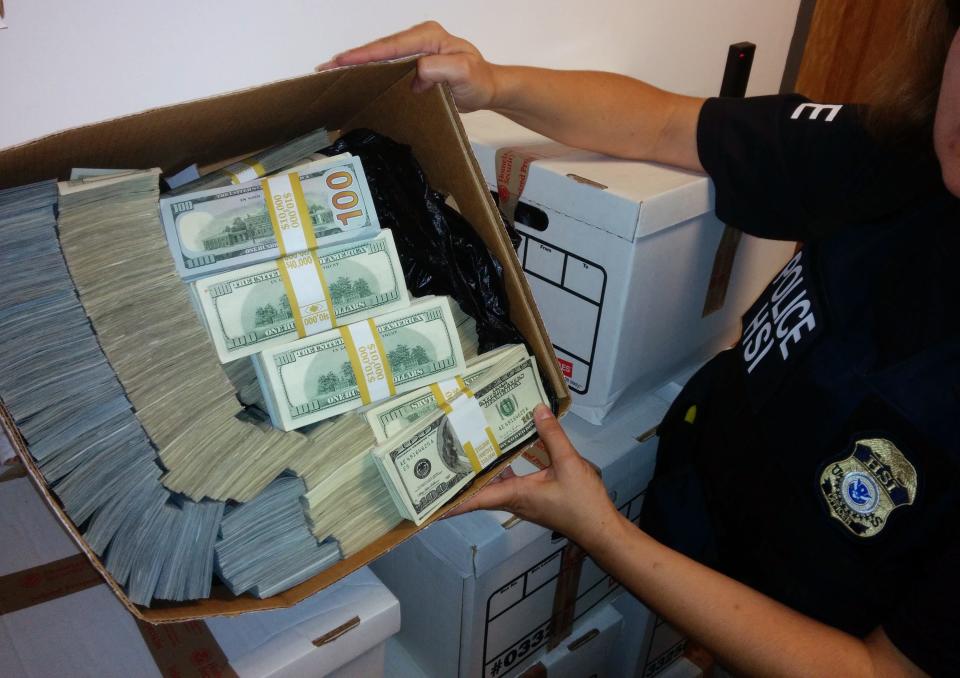 This photo provided by U.S. Immigration and Customs Enforcement shows a box of cash that was among items seized by federal agents in Los Angeles on Sept. 10, 2014. Federal prosecutors said they arrested nine people and seized $65 million in a sweep aimed at alleged money laundering operations.