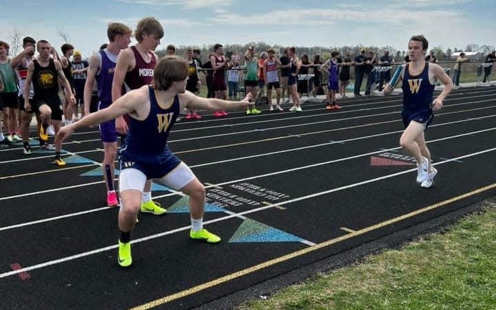 Whiteford's Zach Kohn prepares to pass the baton to teammate Dylan Anderson during the Whiteford Bobcat Relays Saturday.