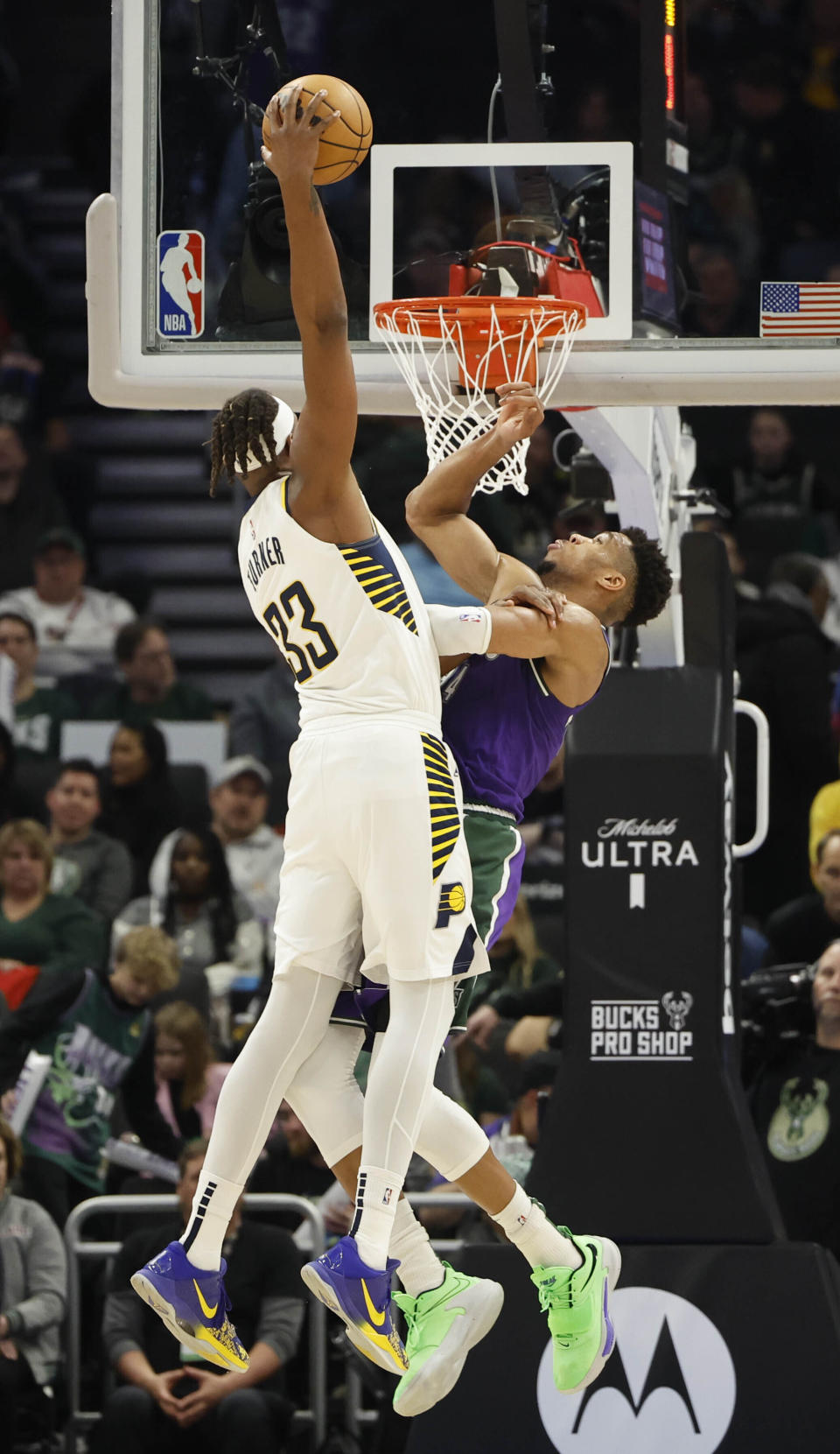 Indiana Pacers center Myles Turner (33) dunks over Milwaukee Bucks forward Giannis Antetokounmpo (34) during the second half of an NBA basketball game Thursday, March 16, 2023, in Milwaukee. (AP Photo/Jeffrey Phelps)