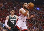 May 21, 2019; Toronto, Ontario, CAN; Toronto Raptors guard Fred VanVleet (23) passes the ball in front of Milwaukee Bucks forward Ersan Ilyasova (77) during the first half in game four of the Eastern conference finals of the 2019 NBA Playoffs at Scotiabank Arena. Mandatory Credit: John E. Sokolowski-USA TODAY Sports