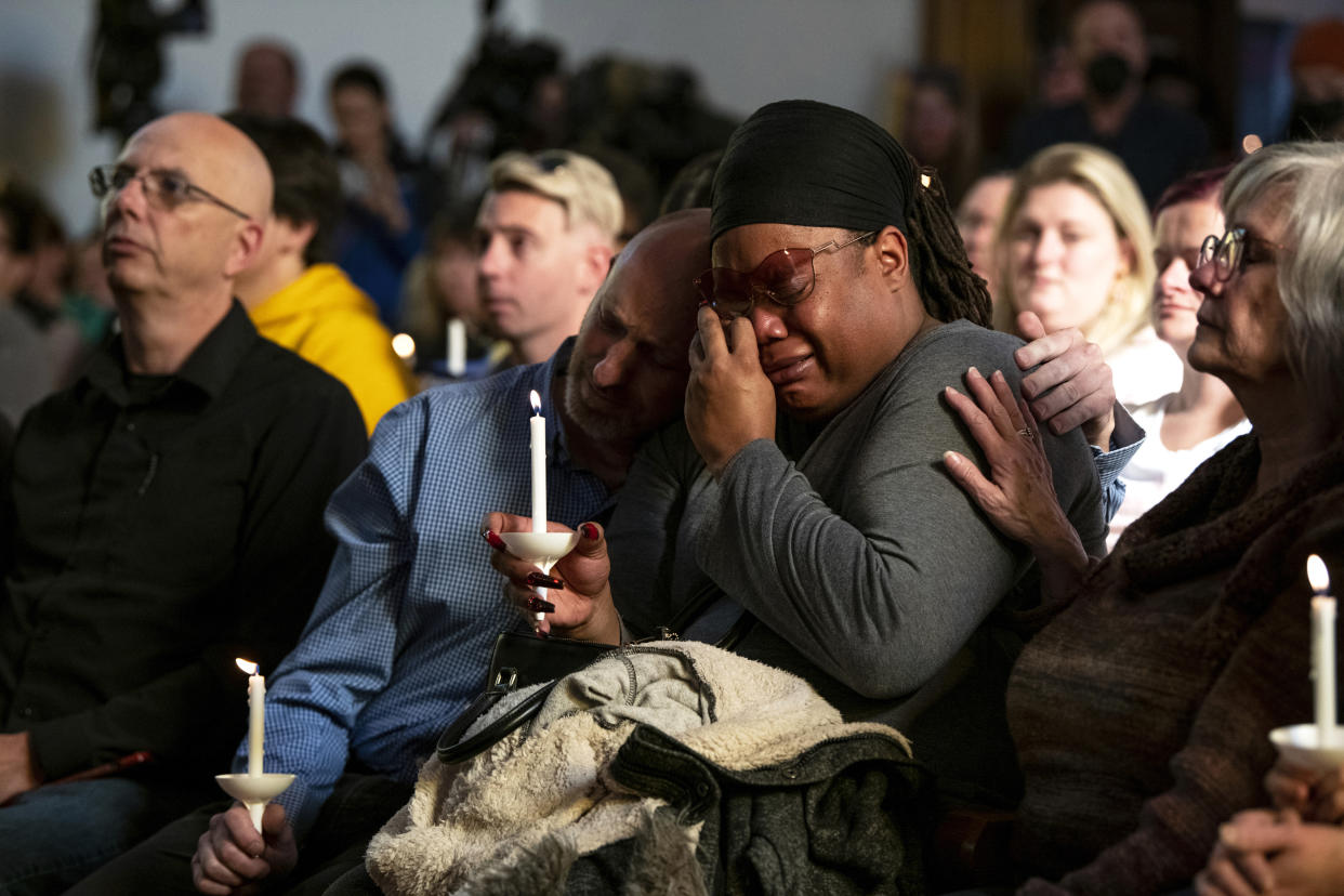 Tyrice Kelley, center right, a performer at Club Q, is comforted during a service held at All Souls Unitarian Church following an overnight fatal shooting at the gay nightclub, in Colorado Springs, Colo., on Sunday, Nov. 20, 2022. (Parker Seibold/The Gazette via AP)