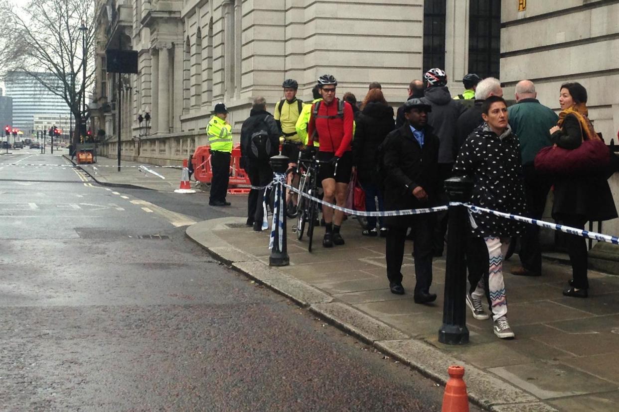 Commuters file past a police cordon in Westminster today