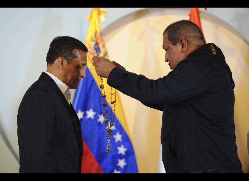 The President of Venezuela, Hugo Chavez (R), decorates his Peruvian counterpart Ollanta Humala, during a ceremony in Bolivar on January 7, 2012. Humala is on an official visit to Venezuela.   AFP PHOTO/Leo RAMIREZ (Photo credit should read LEO RAMIREZ/AFP/Getty Images)