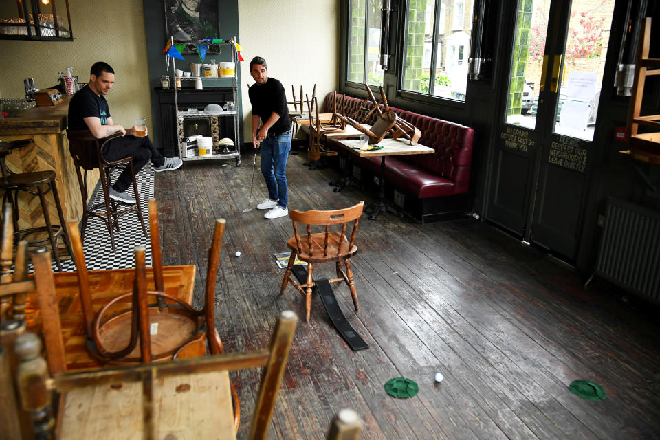 Dominic Townsend and Steve Pond play indoor golf at The Prince, a pub they share an apartment above and say are lucky enough to be stuck in during lockdown as the coronavirus disease (COVID-19) continues in London, Britain April 28, 2020. Picture taken April 28, 2020.  REUTERS/Dylan Martinez u000d     TPX IMAGES OF THE DAY