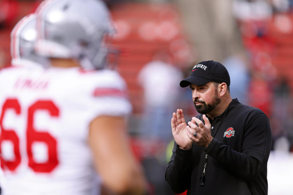 Ohio State head coach Ryan Day claps during warm up before a NCAA college football game against Rutgers, Saturday, Nov. 4, 2023, in Piscataway, N.J. (AP Photo/Noah K. Murray)