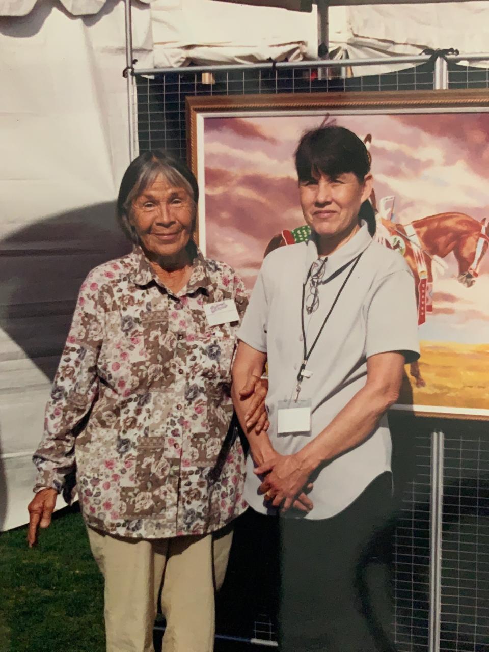 Sandra Okuma with one of her paintings