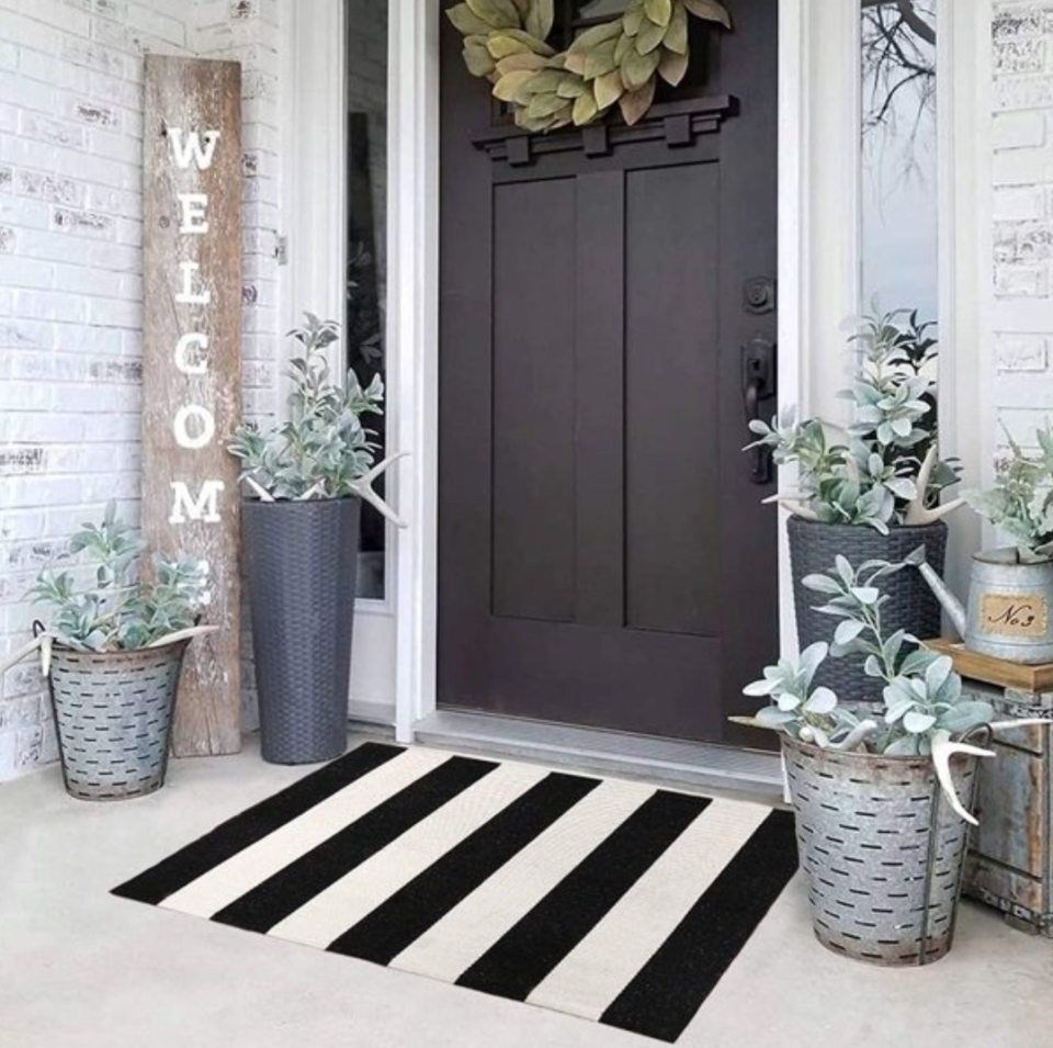 Front door with striped doormat