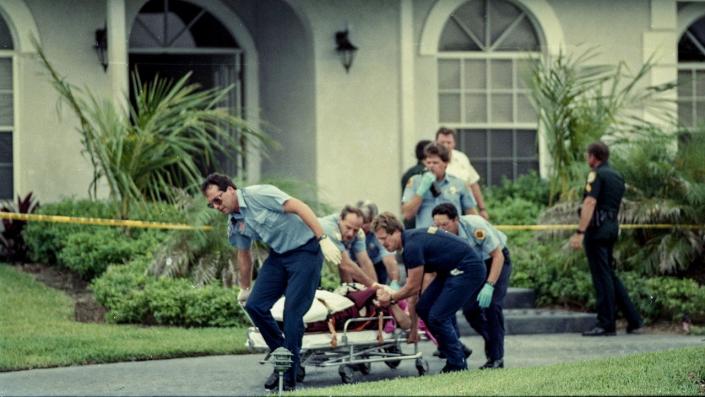 Paramedics transporting victim marlene warren out of florida murder scene