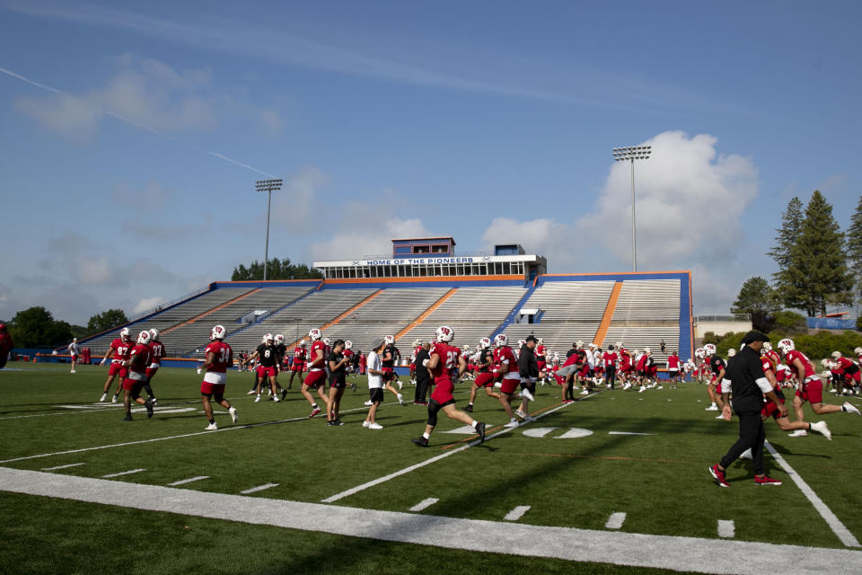 The Wisconsin football team warms up during the second day of football training camp at UW-Platteville in Platteville, Wis., Thursday, Aug. 3, 2023. (Samantha Madar/Wisconsin State Journal via AP)