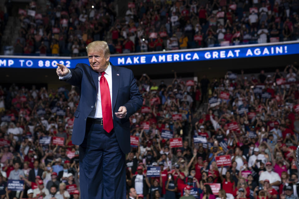 In this June 20, 2020, photo, President Donald Trump arrives on stage to speak at a campaign rally at the BOK Center in Tulsa, Okla. President Donald Trump is sharpening his focus on his ardent base of supporters as polls show a diminished standing for the president in battleground states that will decide the 2020 election (AP Photo/Evan Vucci)