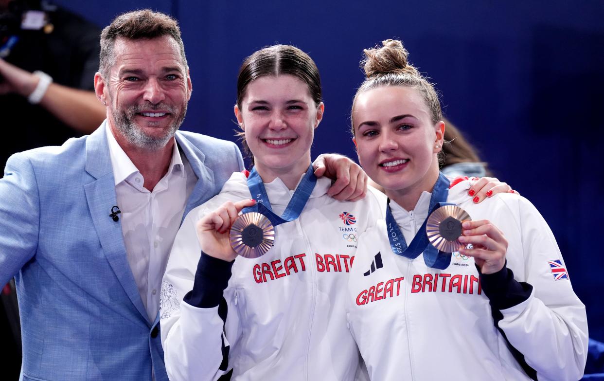 Fred Sirieix with his daughter Andrea Spendolini-Sirieix and her diving partner Lois Toulson following the Women's Synchronised 10m Platform Final at the Aquatics Centre on the fifth day of the 2024 Paris Olympic Games in France. Picture date: Wednesday July 31, 2024.