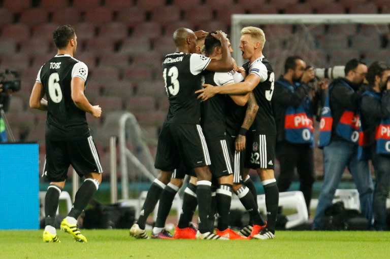 Besiktas' players celebrate after a goal by Besiktas' defender from Brazil Adriano during the UEFA Champions League football match SSC Napoli vs Besiktas on October 19, 2016