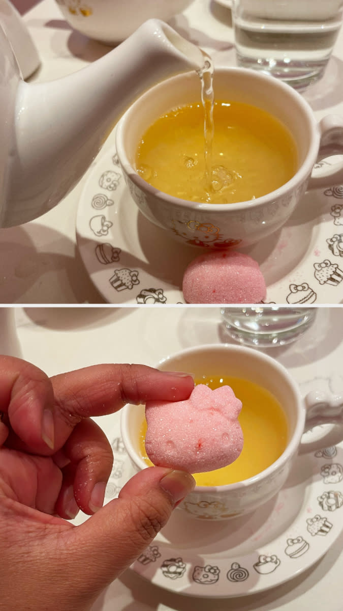 The author is pouring tea and is showing a Hello Kitty-shaped sugar cube